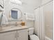 Bathroom featuring a vanity, toilet, and shower with white tiling at 5195 Forest Oaks Dr, Hollywood, SC 29449