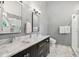 Bathroom with double vanity sinks, mirrors, and marble countertops at 5195 Forest Oaks Dr, Hollywood, SC 29449