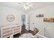 Bedroom featuring a crib, changing table, and hardwood floors at 5195 Forest Oaks Dr, Hollywood, SC 29449