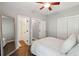 Bright bedroom with hardwood floors, ceiling fan, and closet at 5195 Forest Oaks Dr, Hollywood, SC 29449