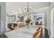 Open-concept dining area with stylish chandelier and wicker chairs near the kitchen at 5195 Forest Oaks Dr, Hollywood, SC 29449