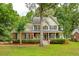 Charming two-story home featuring a well-manicured lawn and inviting front porch at 5195 Forest Oaks Dr, Hollywood, SC 29449