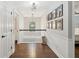 Hallway with hardwood floors, chandelier, and a view to another room at 5195 Forest Oaks Dr, Hollywood, SC 29449