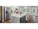 Bright, modern kitchen with stainless steel appliances, marble counters, and wine fridge at 5195 Forest Oaks Dr, Hollywood, SC 29449