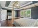 Bedroom featuring a canopy bed, white trim, and many windows at 5195 Forest Oaks Dr, Hollywood, SC 29449