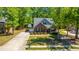 Aerial view features the brick home with a manicured lawn and a paved driveway at 5442 Clearview Dr, North Charleston, SC 29420