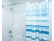 Clean bathroom with a standup shower featuring a modern shower head and a blue striped shower curtain at 5442 Clearview Dr, North Charleston, SC 29420