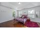 Cozy bedroom with a tray ceiling, wood floors, three windows, and a stylish metal bed frame at 5442 Clearview Dr, North Charleston, SC 29420