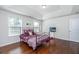 Sunlit bedroom featuring a tray ceiling, two windows, wood floors, and a cozy, decorative bed at 5442 Clearview Dr, North Charleston, SC 29420