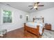 A cozy bedroom with wood floors, soft lighting, a large window, and stylish decor at 5442 Clearview Dr, North Charleston, SC 29420