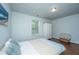 Comfortable bedroom with a window view, hardwood floors, a cozy bed, and soft, natural lighting at 5442 Clearview Dr, North Charleston, SC 29420