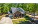 Inviting brick home with lush lawn and an attached garage, surrounded by beautiful trees offering shade and serenity at 5442 Clearview Dr, North Charleston, SC 29420
