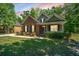 Well-maintained brick home featuring a cozy front porch and neatly trimmed landscaping, set on a green lawn at 5442 Clearview Dr, North Charleston, SC 29420