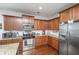 Modern kitchen featuring stainless steel appliances, granite countertops, and warm wood cabinetry providing ample storage at 5442 Clearview Dr, North Charleston, SC 29420