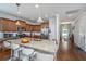 Spacious kitchen with a large granite island featuring bar seating, stainless steel appliances, and warm wood cabinetry at 5442 Clearview Dr, North Charleston, SC 29420