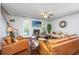 Inviting living room features a cozy fireplace, bright windows, and plush leather seating at 5442 Clearview Dr, North Charleston, SC 29420