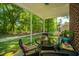Charming screened porch with a table and chairs, ideal for outdoor dining and enjoying the view at 5442 Clearview Dr, North Charleston, SC 29420