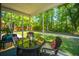 Inviting screened porch with seating and a table overlooking the lush backyard, perfect for relaxation at 5442 Clearview Dr, North Charleston, SC 29420