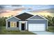 Charming single-story home with a cozy front yard, complemented by blue siding and beautiful landscaping at 5516 Bowmore Blvd, Ravenel, SC 29470