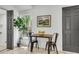 Cozy dining area with black chairs, a wooden table, a leafy green plant, and natural light from the nearby window at 5817 Canterbury Dr, Hanahan, SC 29410