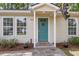 Inviting home front door with teal door and colorful welcome rug at 5817 Canterbury Dr, Hanahan, SC 29410