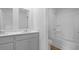 Bathroom with double sinks, white cabinets, and a shower/tub combo at 6039 Savy Ct, Ravenel, SC 29470