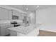 Modern kitchen featuring gray cabinets, stainless steel appliances, granite countertops, and a large island at 6039 Savy Ct, Ravenel, SC 29470