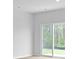 A bright, open living area with modern gray walls and light wood floors leading to a glass sliding door at 6039 Savy Ct, Ravenel, SC 29470