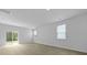 Sun-filled living room with sliding glass doors and light-colored hardwood floors, perfect for entertaining at 6039 Savy Ct, Ravenel, SC 29470