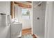This bathroom features wood-look floors, shiplap accent walls, a vanity, and a shower with white subway tile at 622 E Cooper Ave, Folly Beach, SC 29439