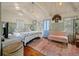 Cozy bedroom featuring vaulted ceilings, hardwood floors, and beach decor at 622 E Cooper Ave, Folly Beach, SC 29439