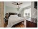 Bright bedroom features ceiling fan, shiplap accent wall, and convenient stacked washer/dryer units in custom alcove at 622 E Cooper Ave, Folly Beach, SC 29439