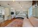 Spacious bedroom featuring high ceilings, hardwood floors, and cozy seating area at 622 E Cooper Ave, Folly Beach, SC 29439