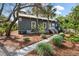 Charming home exterior with well-maintained landscaping and a stone walkway, enhancing curb appeal at 622 E Cooper Ave, Folly Beach, SC 29439