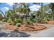 Inviting exterior with mature landscaping providing shade, surrounded by mulch and greenery at 622 E Cooper Ave, Folly Beach, SC 29439