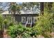 Charming home showcasing a welcoming entrance, verdant foliage, and meticulous landscaping at 622 E Cooper Ave, Folly Beach, SC 29439