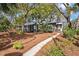 Charming home features a well-manicured lawn and a inviting walkway that leads to the front entrance at 622 E Cooper Ave, Folly Beach, SC 29439