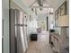 Hallway with stainless steel refrigerator, vintage decor, and view of bright, airy living area at 622 E Cooper Ave, Folly Beach, SC 29439