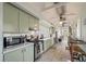 Bright kitchen featuring stainless steel appliances, quartz countertops, and shaker cabinets at 622 E Cooper Ave, Folly Beach, SC 29439