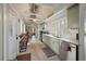 Charming kitchen with custom cabinets, stainless steel appliances, and unique glass block window at 622 E Cooper Ave, Folly Beach, SC 29439