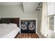 This primary bedroom has in-unit washer and dryer for easy and convenient laundry days at 622 E Cooper Ave, Folly Beach, SC 29439