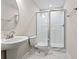 Well-lit bathroom features a sleek pedestal sink, toilet, and glass enclosed shower with modern fixtures at 769 Maynard Ln, Summerville, SC 29486