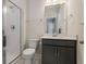 Modern bathroom with a walk-in shower, toilet, and vanity with a dark gray cabinet at 769 Maynard Ln, Summerville, SC 29486