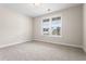 A bright, carpeted bedroom with a large window offering ample natural light at 769 Maynard Ln, Summerville, SC 29486