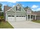 Charming two-story home features a large three car garage and manicured lawn at 769 Maynard Ln, Summerville, SC 29486