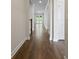 Long hallway with dark wood floors leads to a pair of glass patio doors at 769 Maynard Ln, Summerville, SC 29486