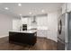Modern kitchen featuring a large island, stainless steel appliances, and white cabinetry at 769 Maynard Ln, Summerville, SC 29486