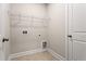 Laundry room with tile floors, wire shelf, and utility connections at 769 Maynard Ln, Summerville, SC 29486