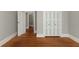 A view of a bedroom featuring hardwood floors and neutral wall paint, and a closet with modern sliding doors at 8 Pitt St # A, Charleston, SC 29401