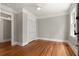 Bedroom featuring hardwood floors, neutral wall paint, closet with modern sliding doors, and natural light from windows at 8 Pitt St # A, Charleston, SC 29401